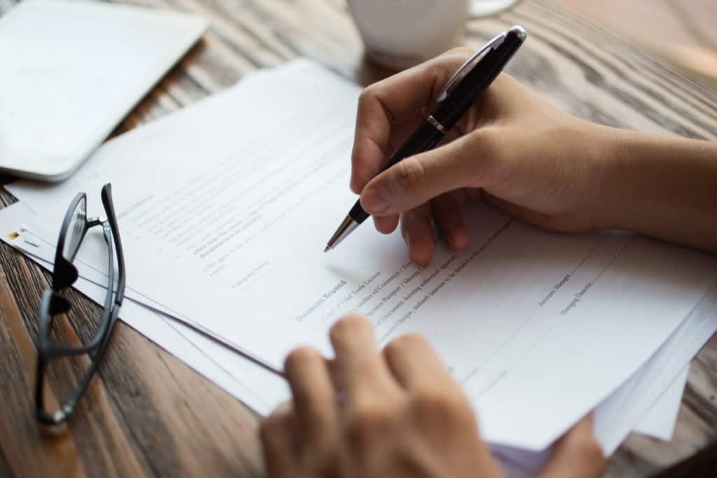 Businessman examining papers at table Businessman examining papers at table